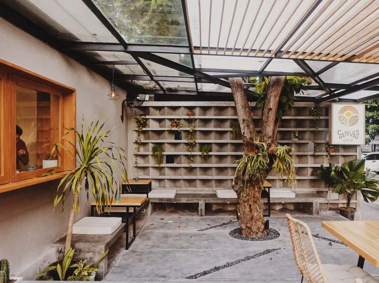 Open-air courtyard seating at a Bali cafe where cards are accepted